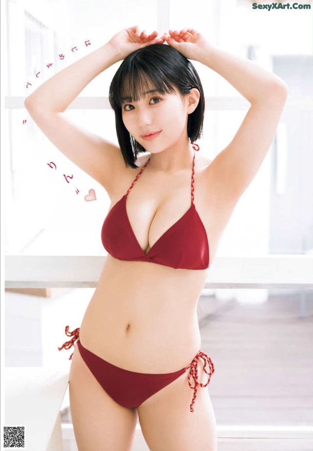 A woman in a red bikini posing for a picture.